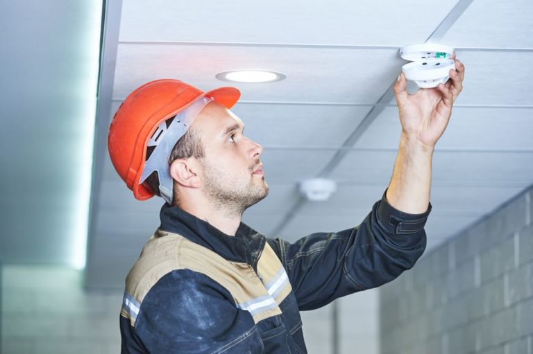 Man Installing Alarm — Security Systems & CCTV in Port Macquarie, NSW